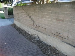 This brick fence is seriously cracked